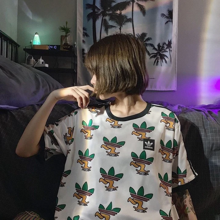 Worn — allover trefoil-character tee, shot from behind