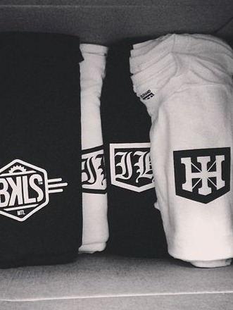 Folded sweats stacked, Breakless and Idlehand marks on the leg