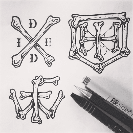 Inked studies — crossed bones, IH crest and monogram lockups on paper