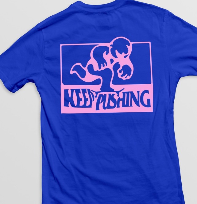 Blue tee with the pink Keep Pushing logo panel