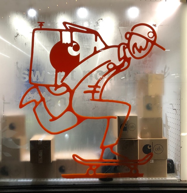 The character painted in red across a shop window