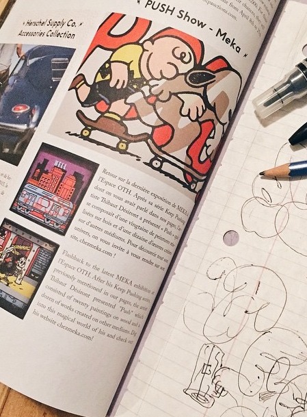 The characters printed in a magazine, next to the sketchbook they came from