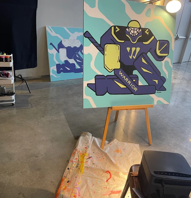 The finished canvas on the easel, lit, ready for camera